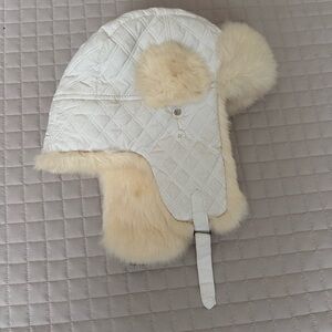 white quilted faux fur-lined trapper hat